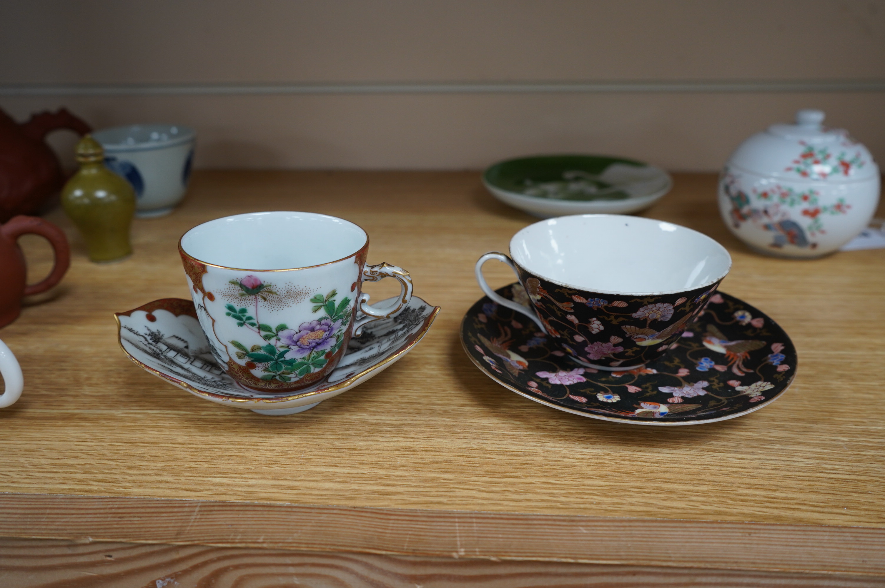 A group of Chinese and Japanese ceramics to include Yixing teapots, porcelain cups and saucers, a blue and white vase and a tiger talisman. Condition - mostly good